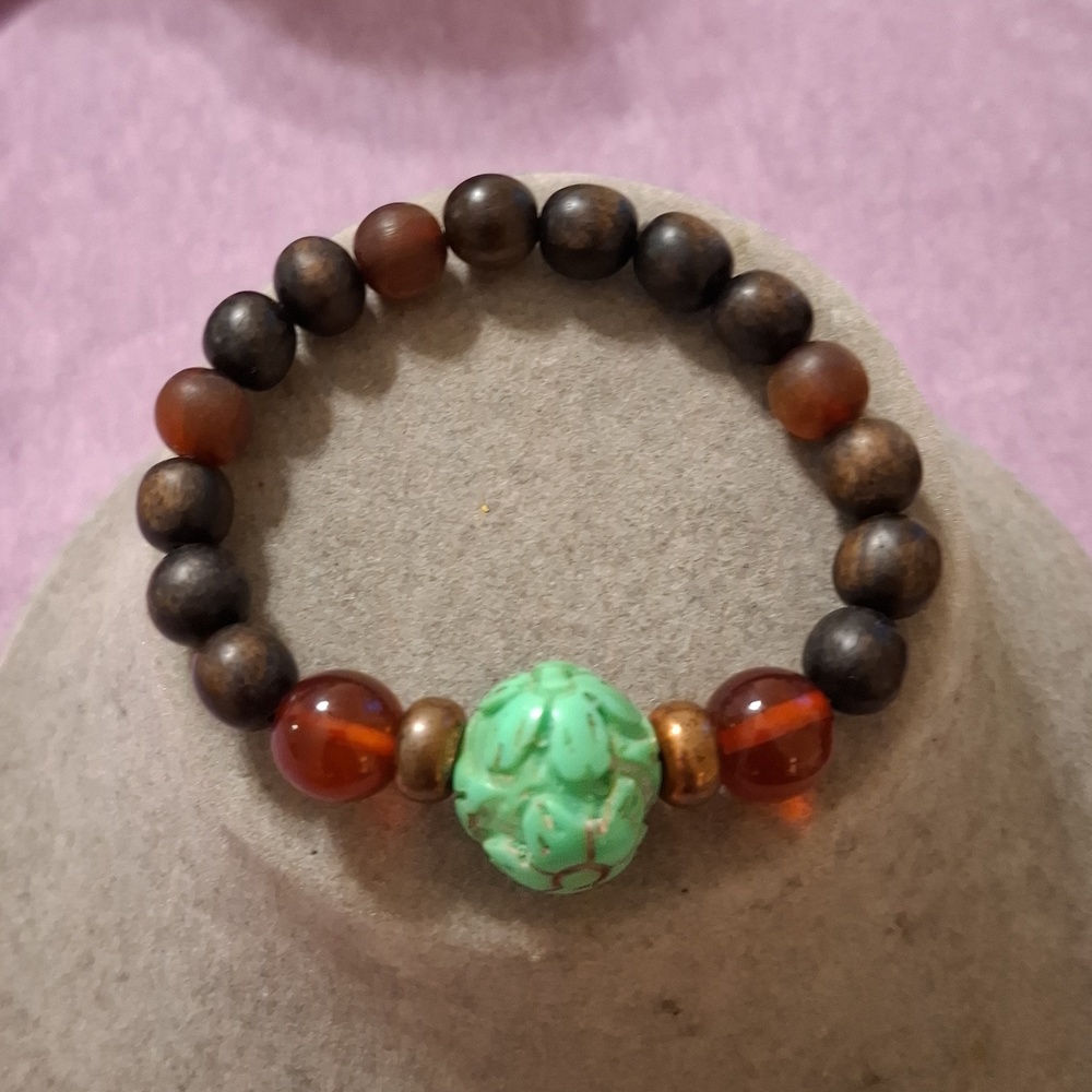 Beaded stretch bracelet. Wooden beads with amber sccent beads and floral accent